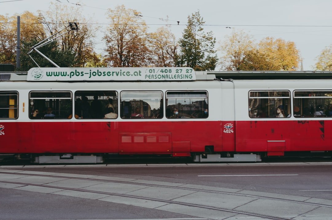 red and white tram on road during daytime