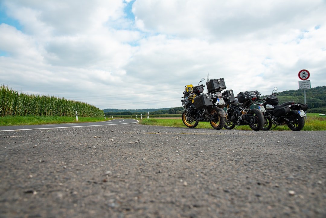 two motorcycles parked on the side of the road