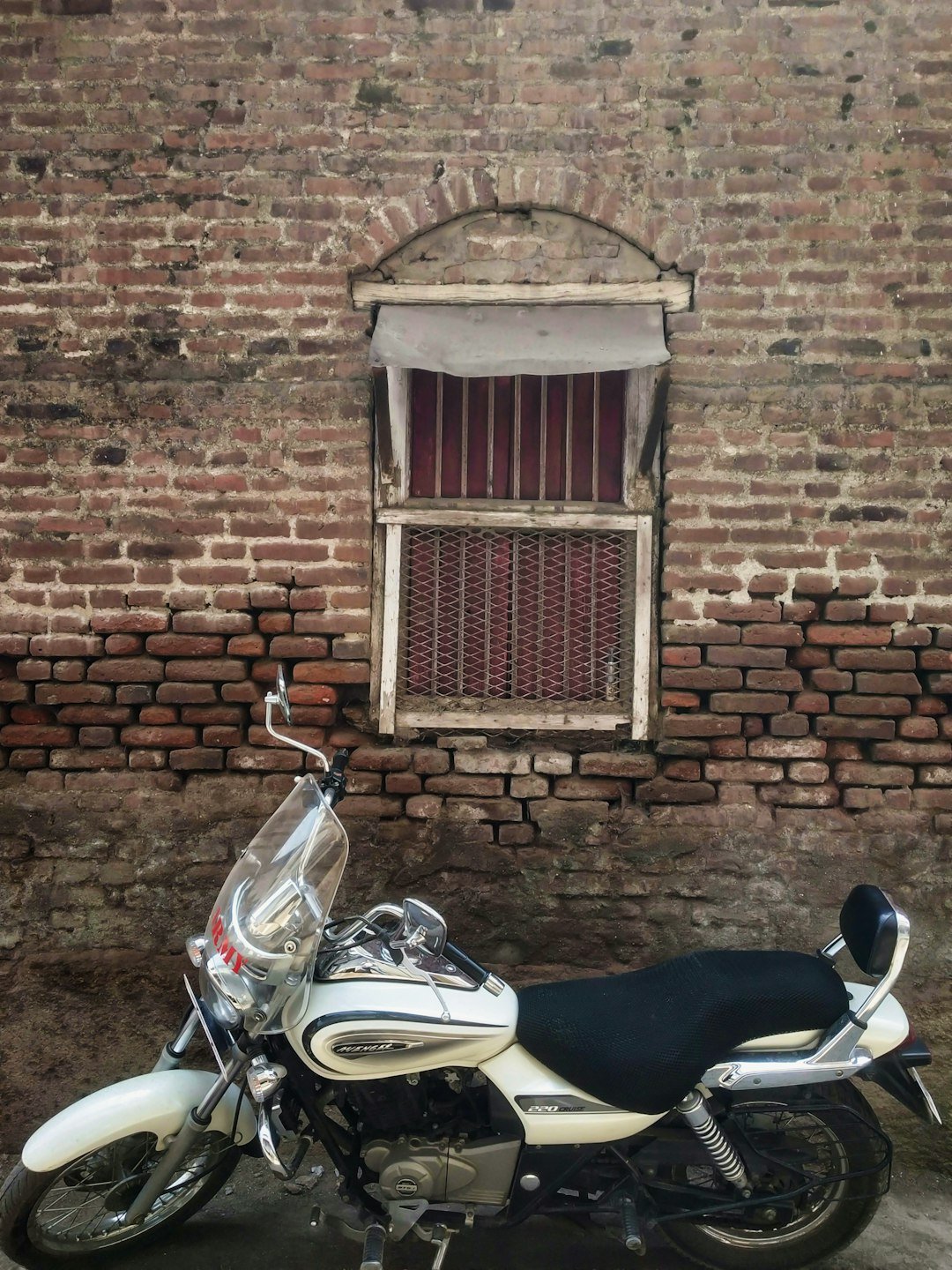 a motorcycle parked in front of a brick building