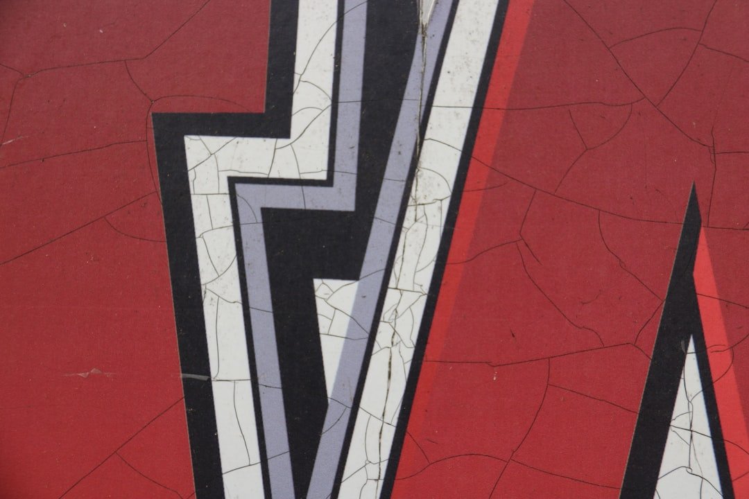 a close up of a wall with a red and black design on it