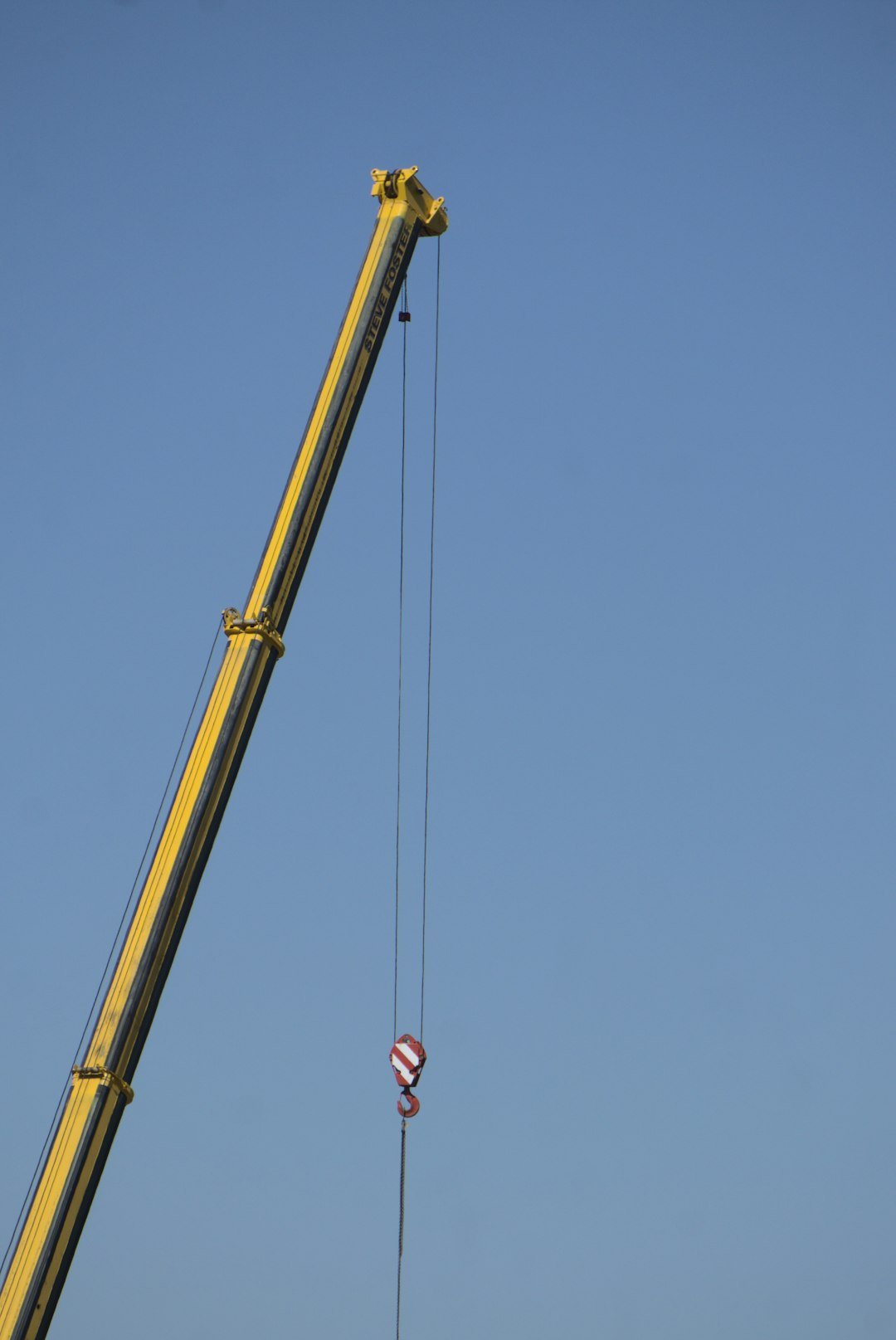 yellow crane under blue sky during daytime
