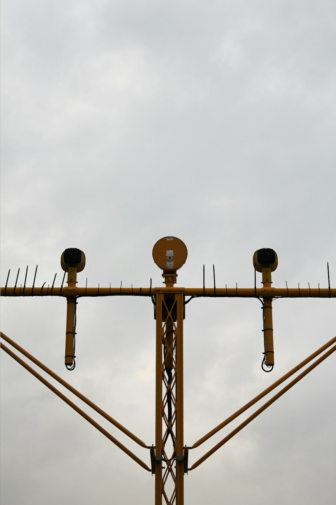 a cell phone tower with three cell phones on top of it