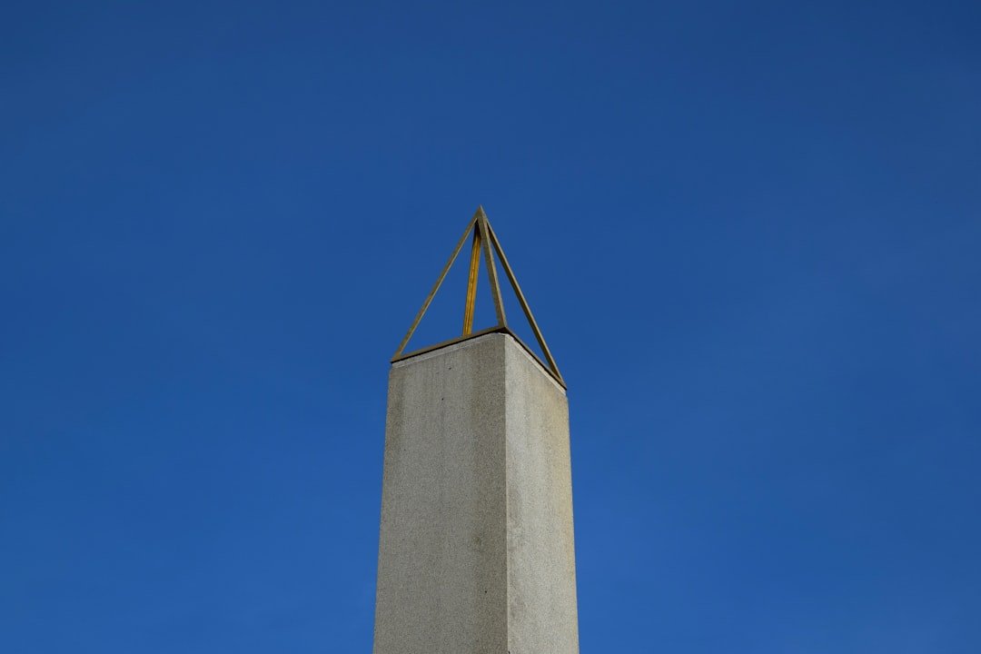 a tall tower with a cross on top