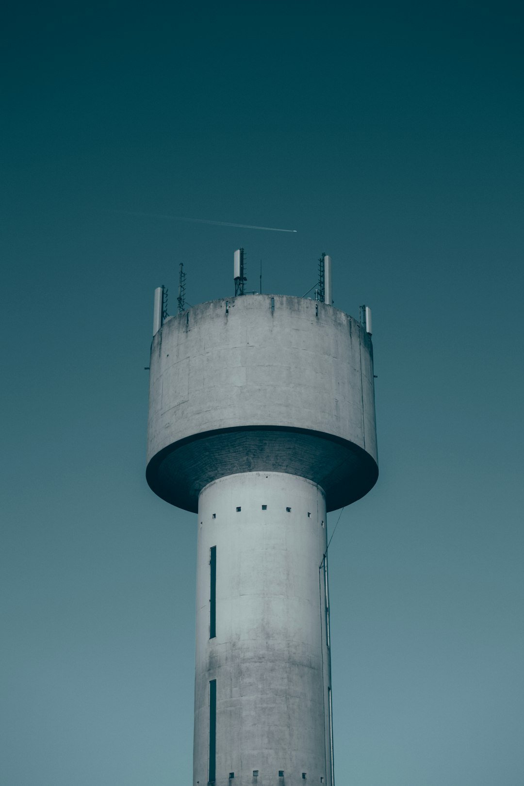 white and blue water tank under blue sky during daytime