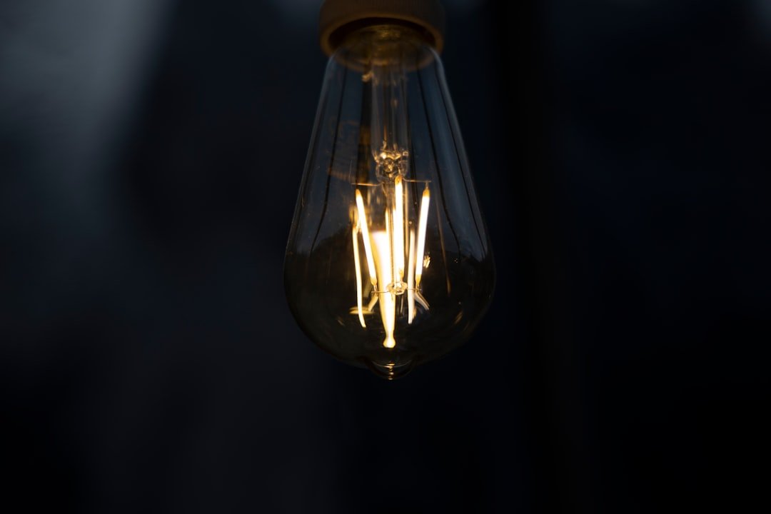 clear glass pendant lamp turned on in dim lit room