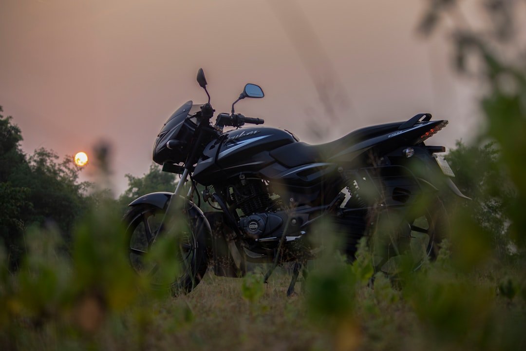 a motorcycle is parked in a grassy field