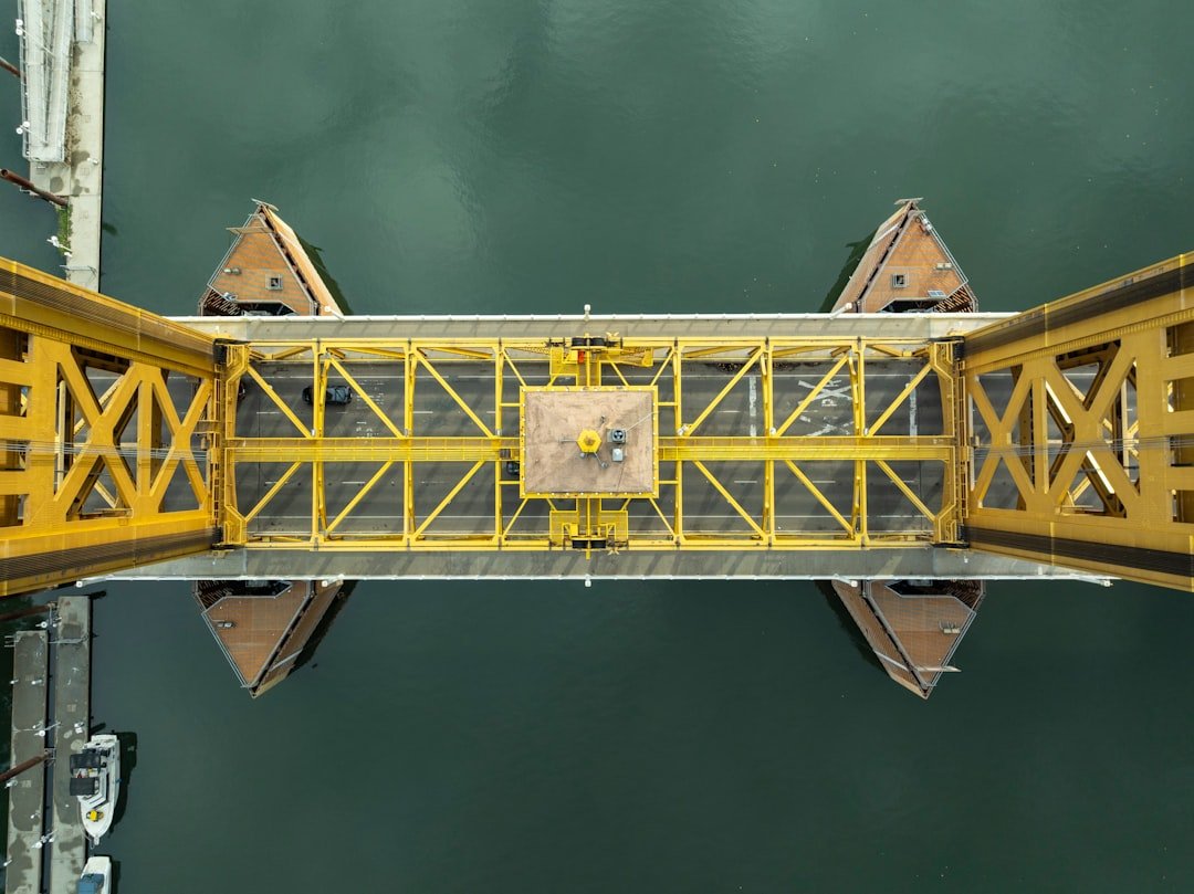 A yellow bridge over a body of water