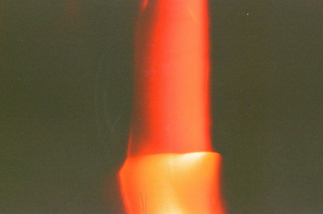 a close up of a red object with a blurry background