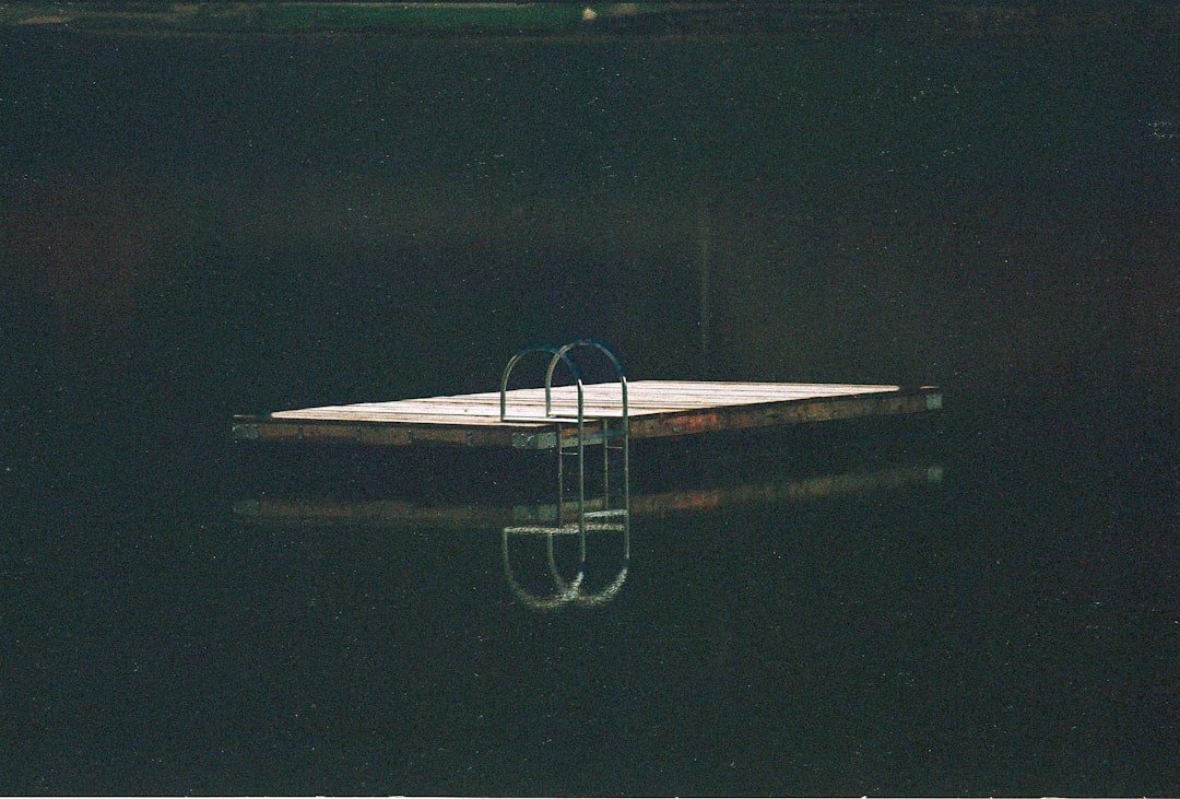 a small boat floating on top of a body of water