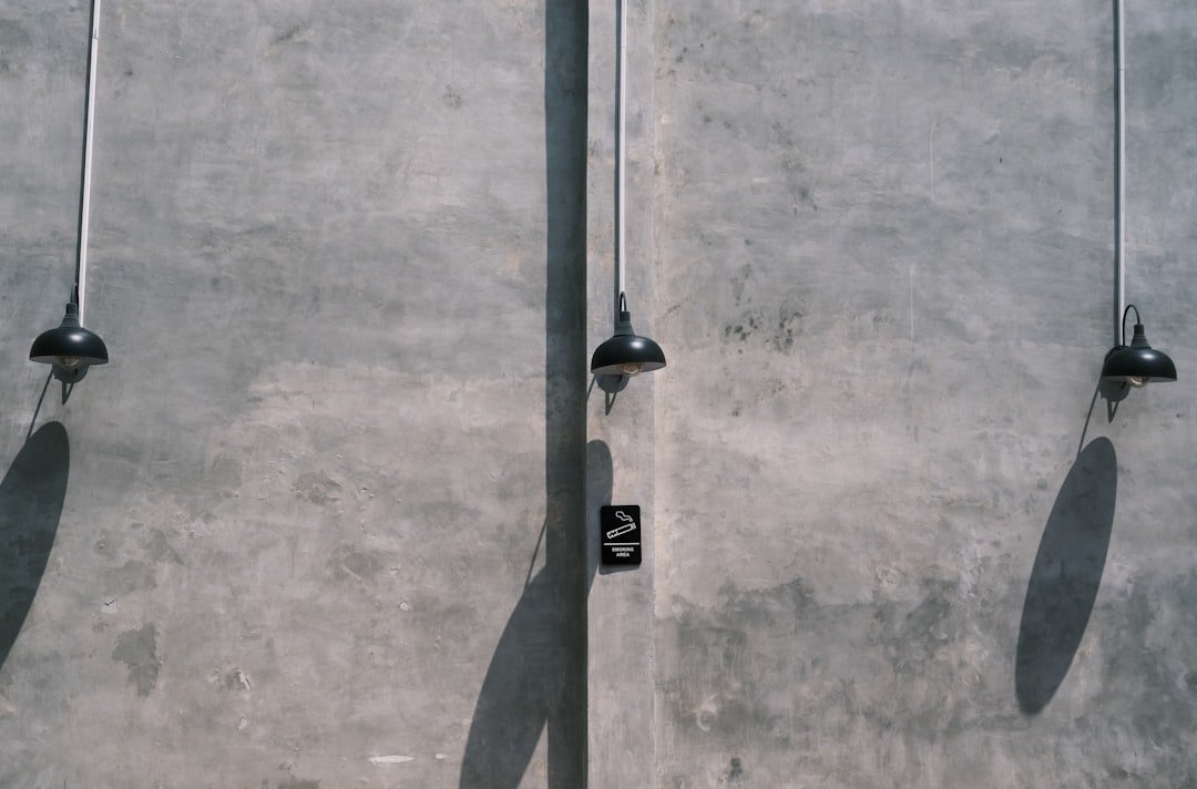 A skateboard is leaning against a pole