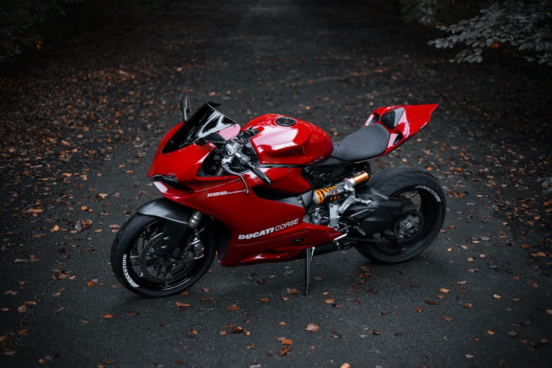 a red motorcycle parked on the side of a road