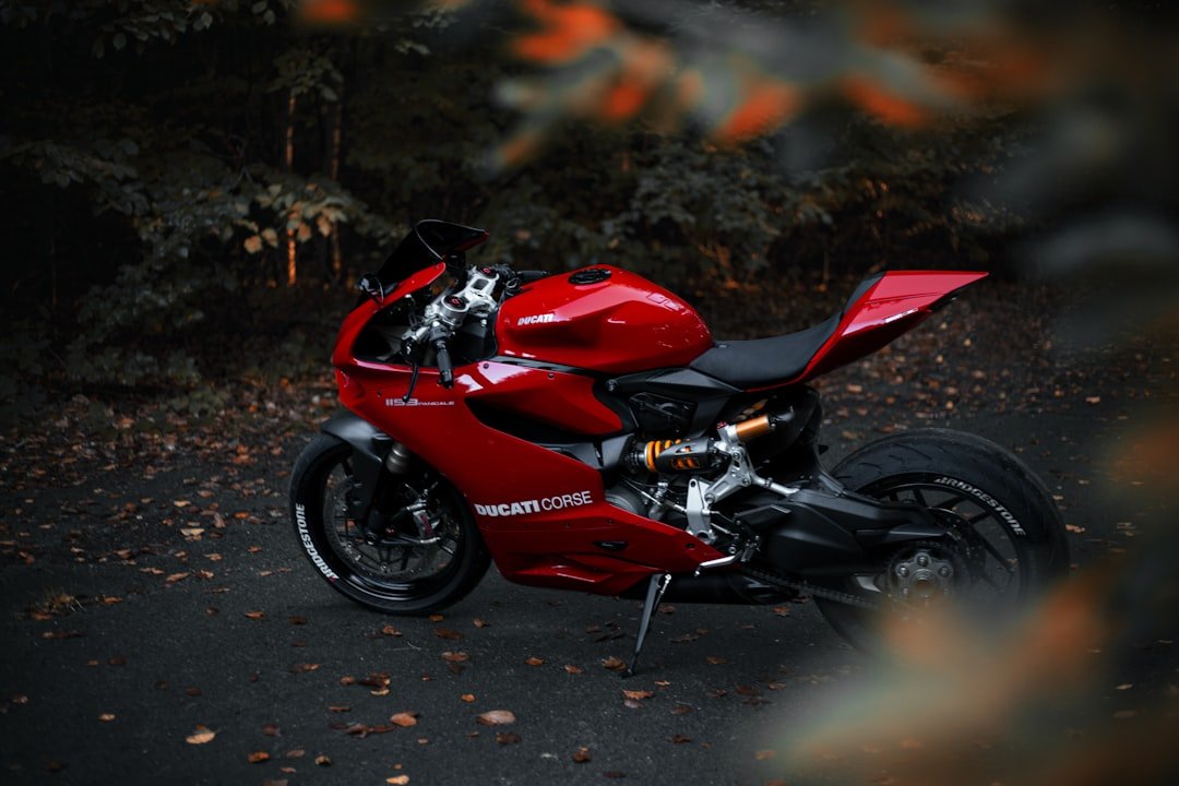 a red motorcycle parked on the side of a road