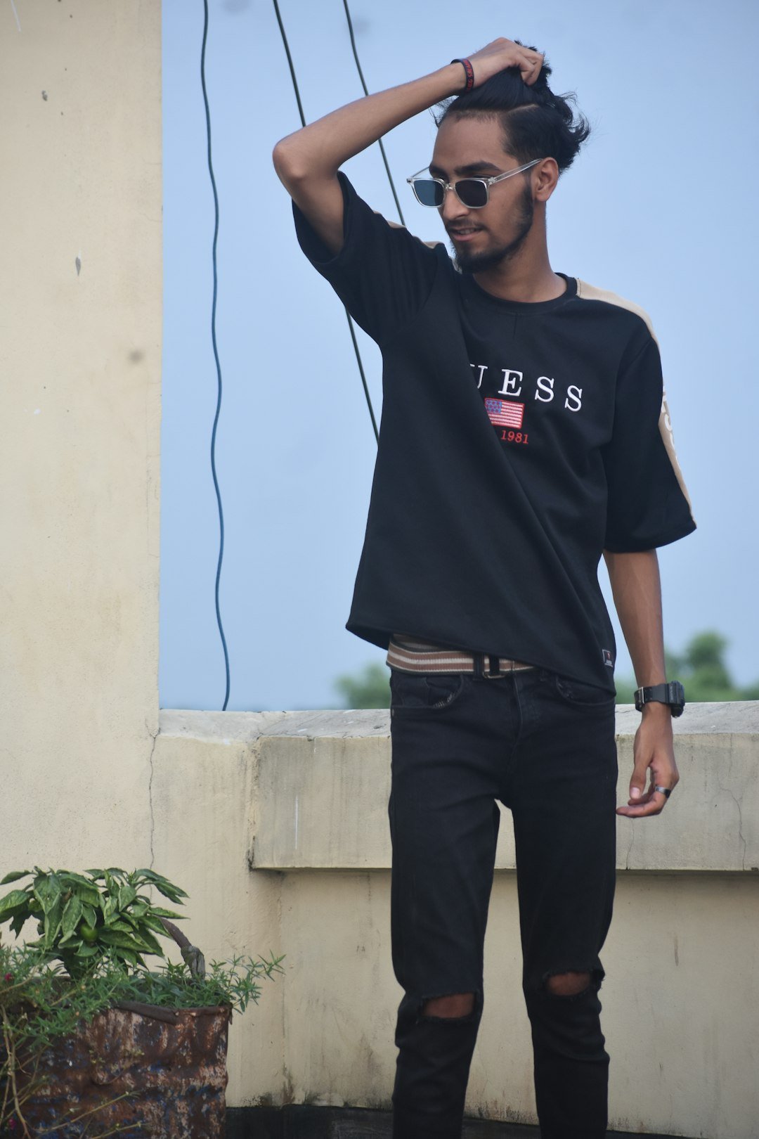 a man with sunglasses and a black shirt