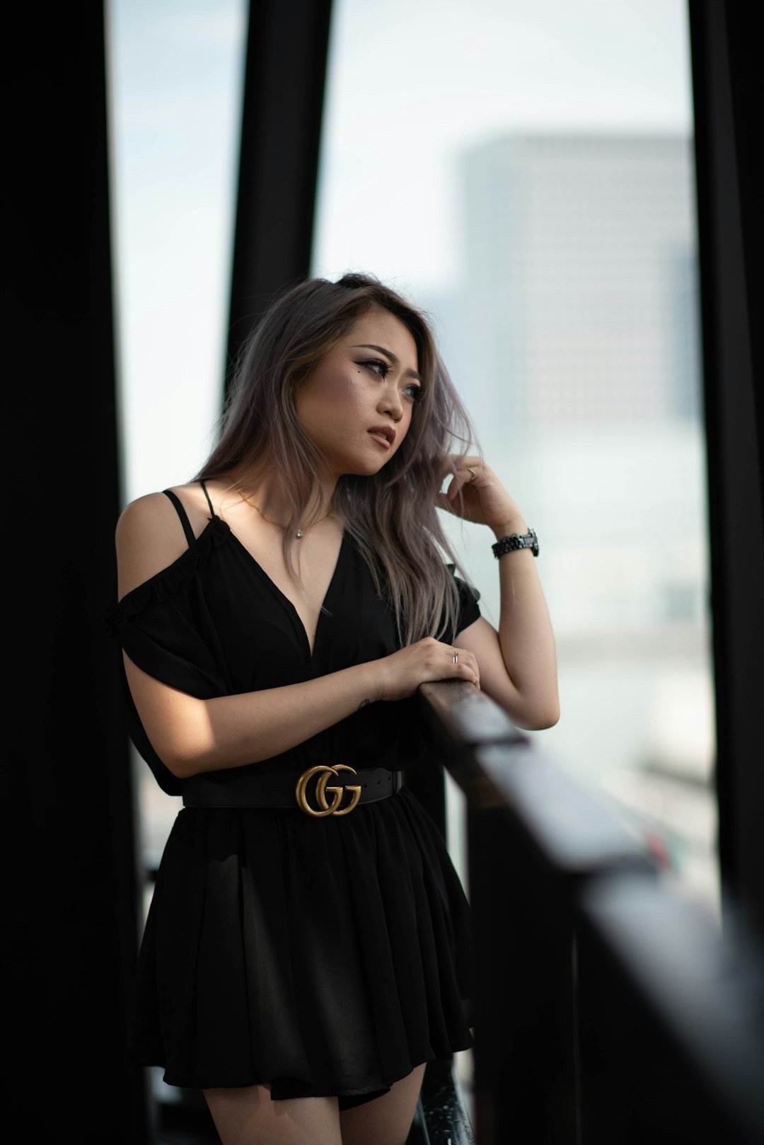 a woman in a black dress posing for a picture