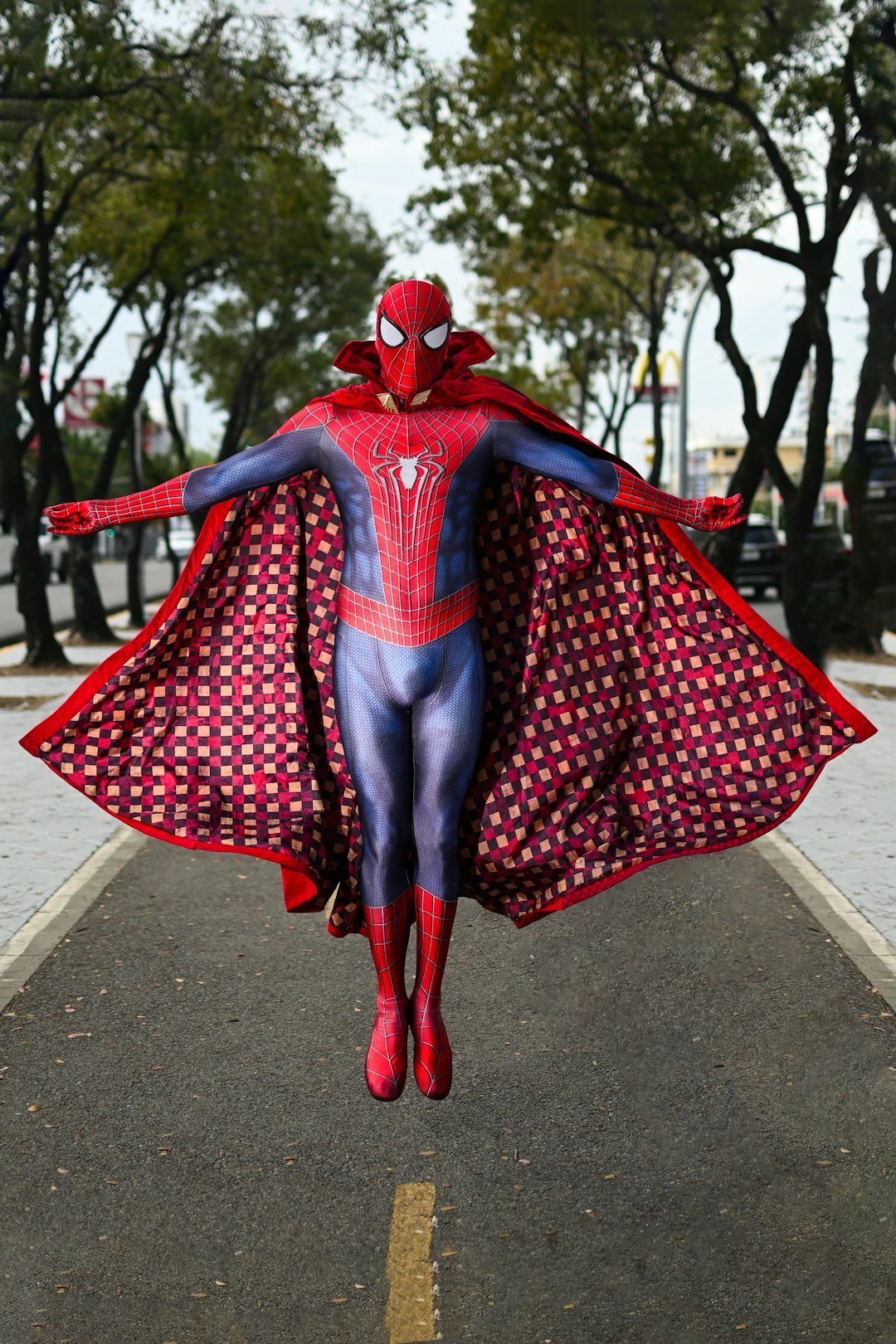 a man in a spider suit is walking down the street