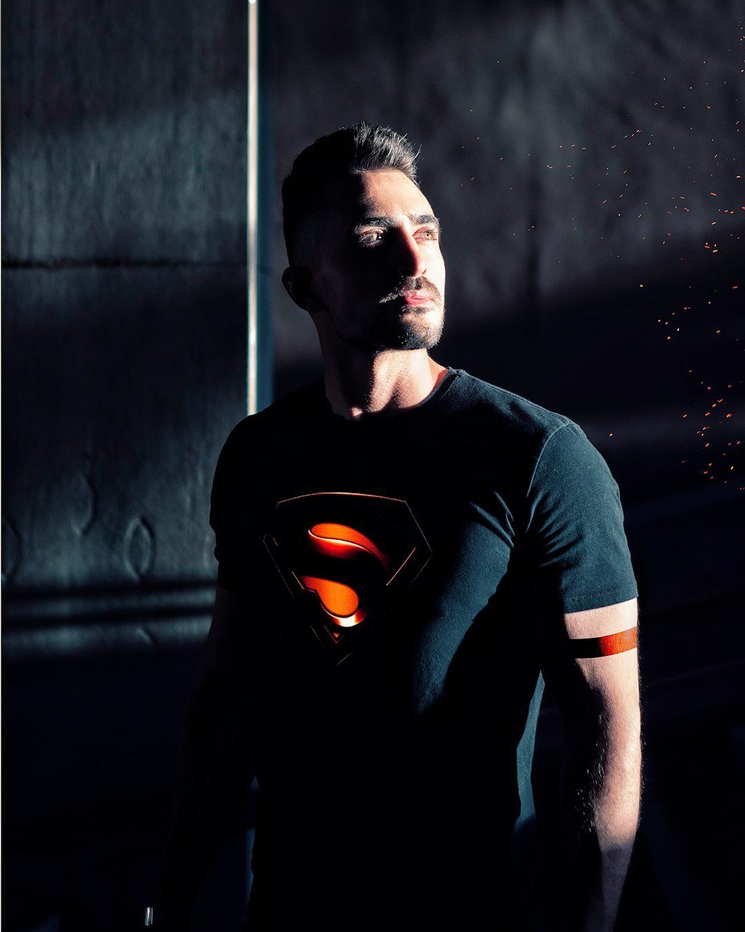 man wearing black Superman shirt