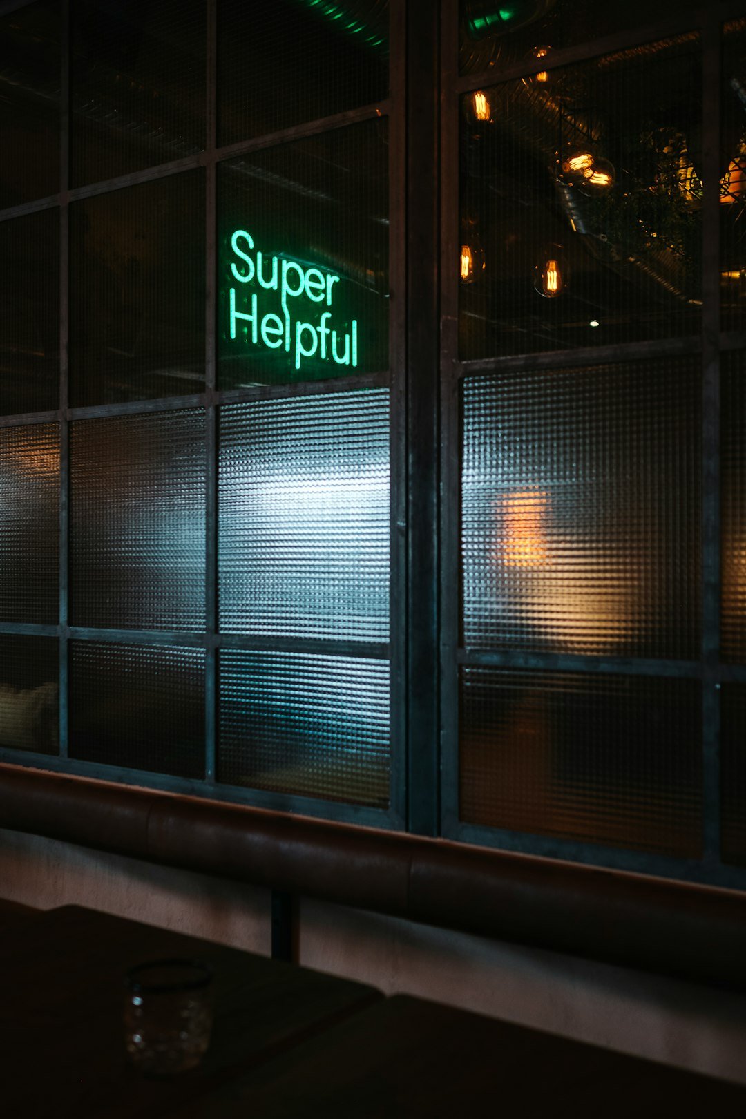 green Super helpful neon signage near window