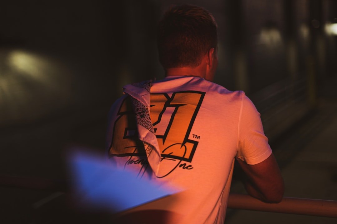 man in pink crew neck t-shirt with backpack