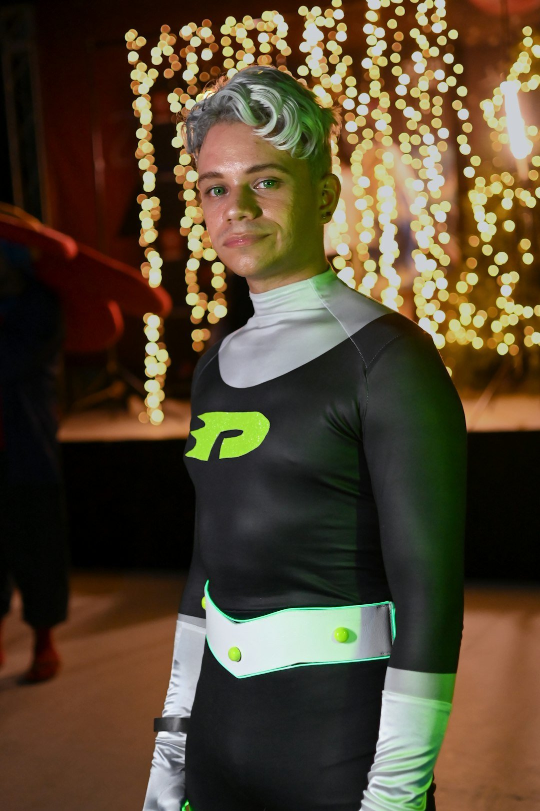 a man dressed in a black and green costume