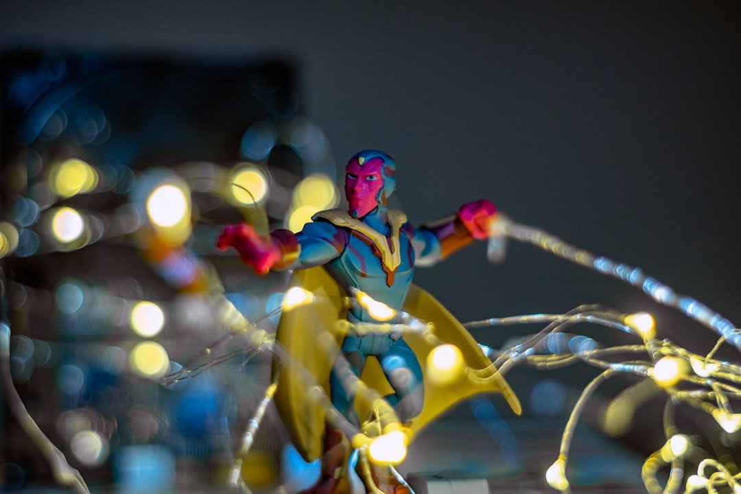 red haired woman in blue and yellow dress holding sword figurine