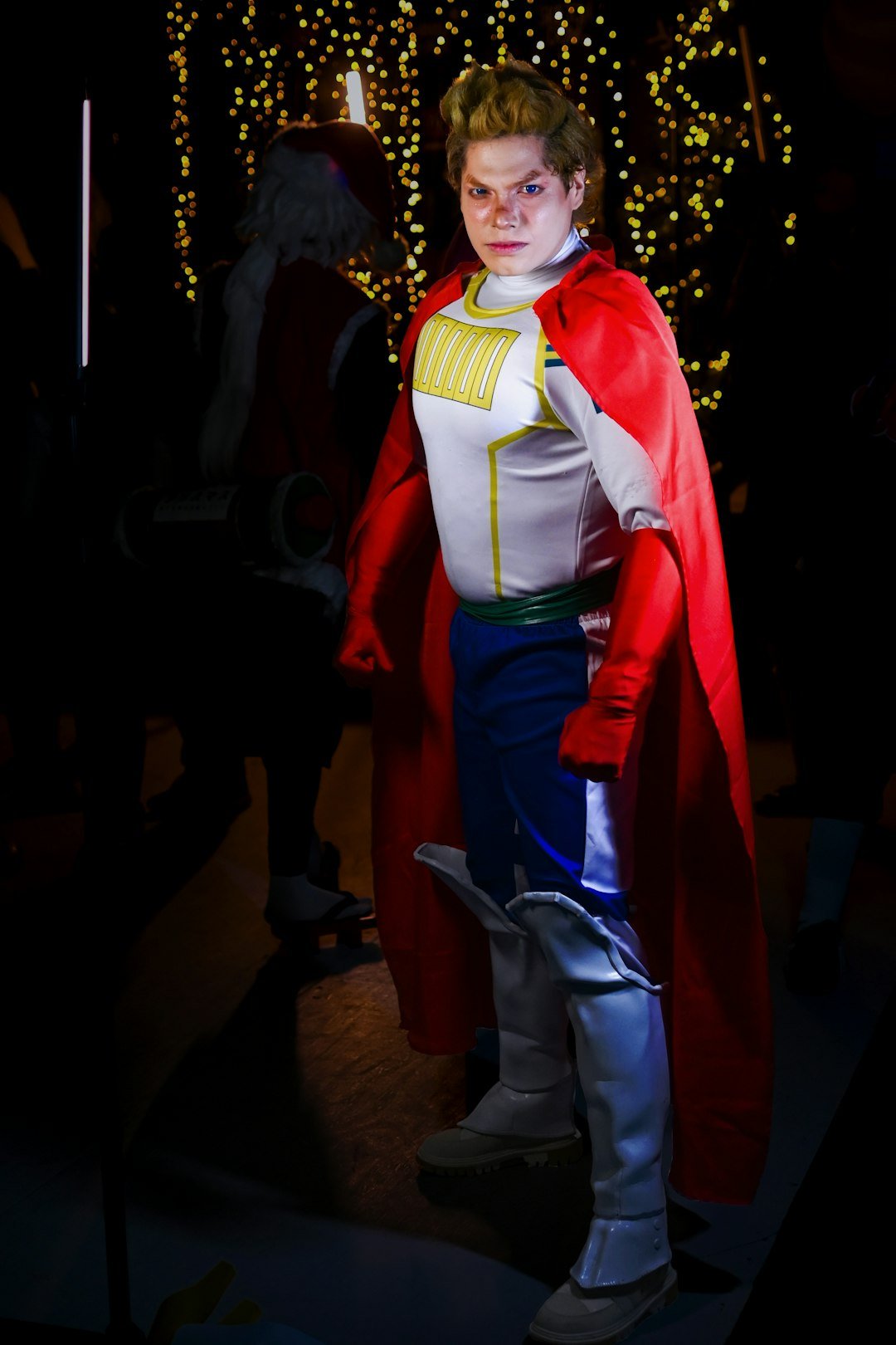 a man dressed in a costume standing in a dark room