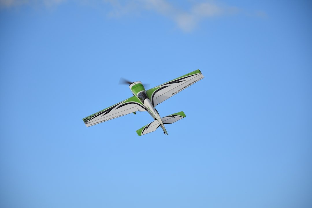 white and green biplane