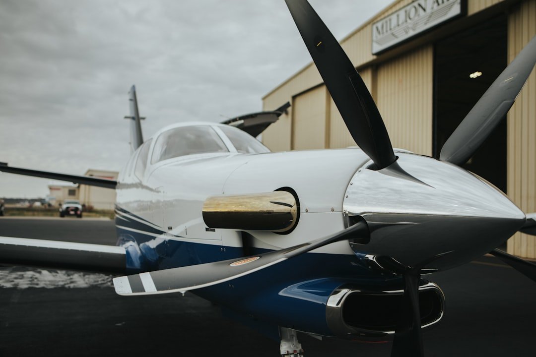 a small airplane parked in front of a building