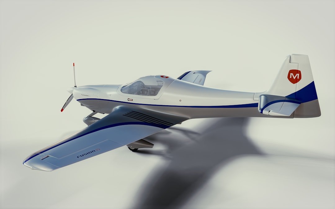 A small airplane flying through a cloudy sky