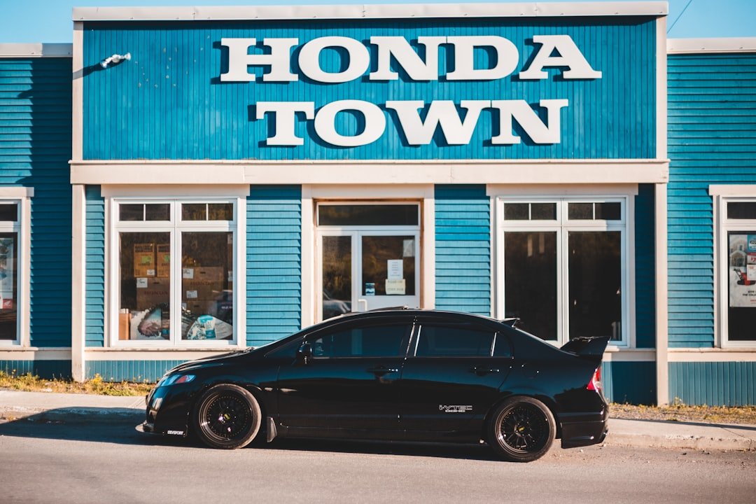 a black car parked in front of a blue building