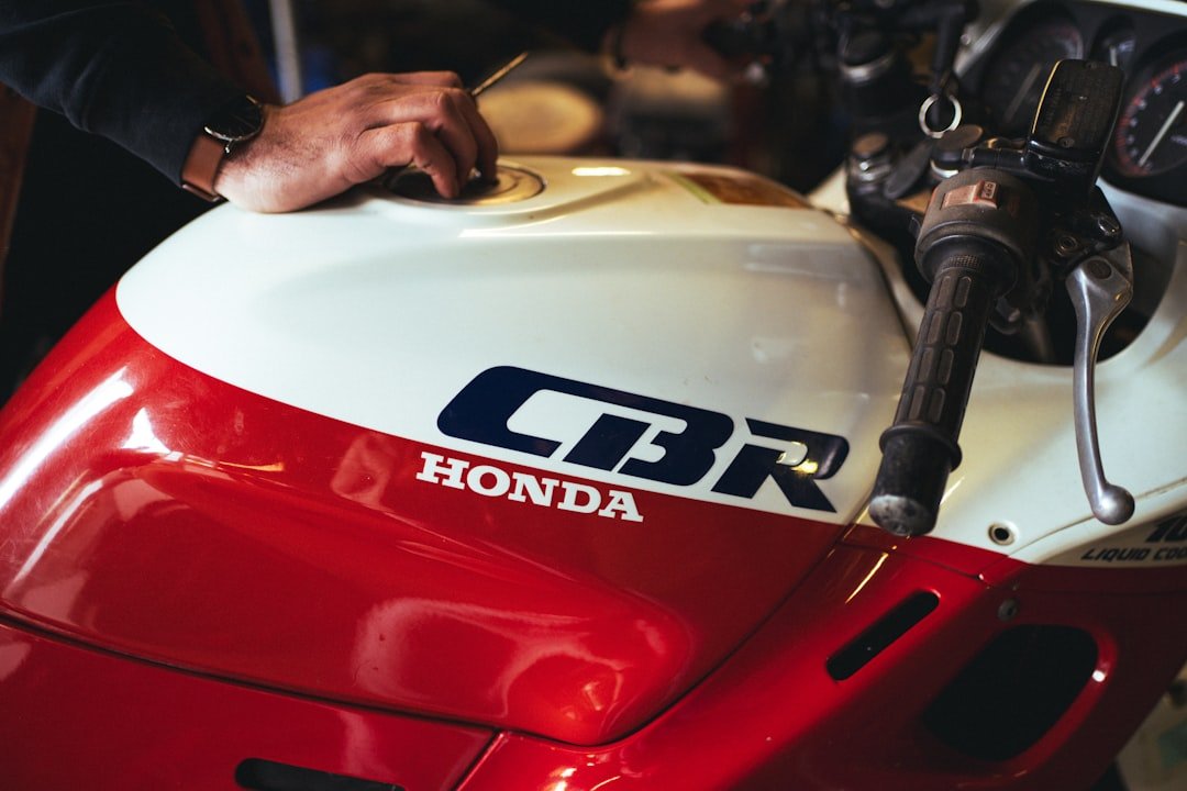 a close up of a person working on a motorcycle