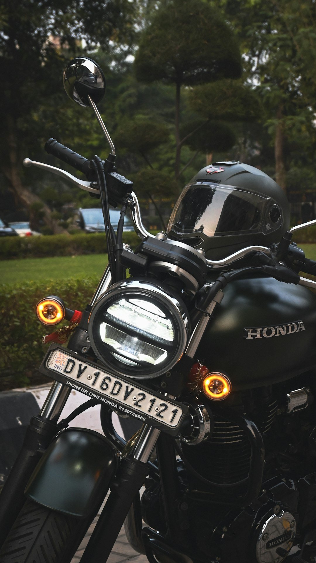 A honda motorcycle with a helmet sits outdoors.