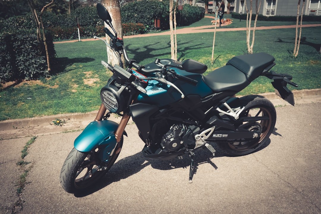 a blue motorcycle parked on the side of the road