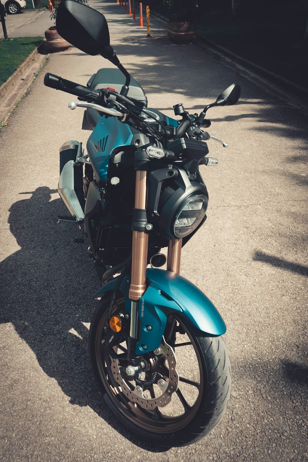 a blue motorcycle parked on the side of a road