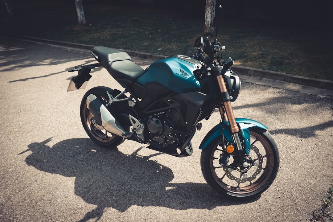 a blue motorcycle parked on the side of a road
