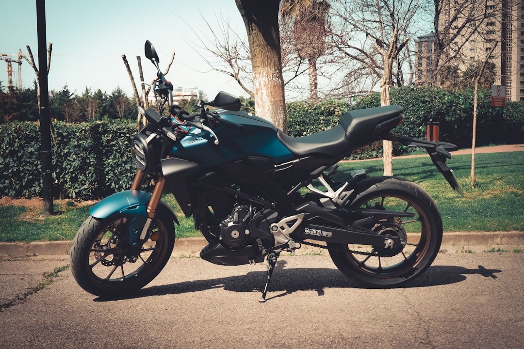 a blue motorcycle parked on the side of the road