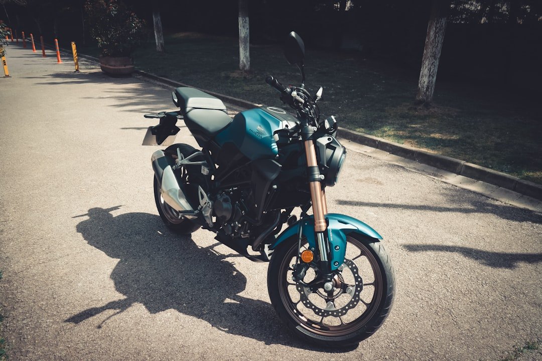 a blue motorcycle parked on the side of a road