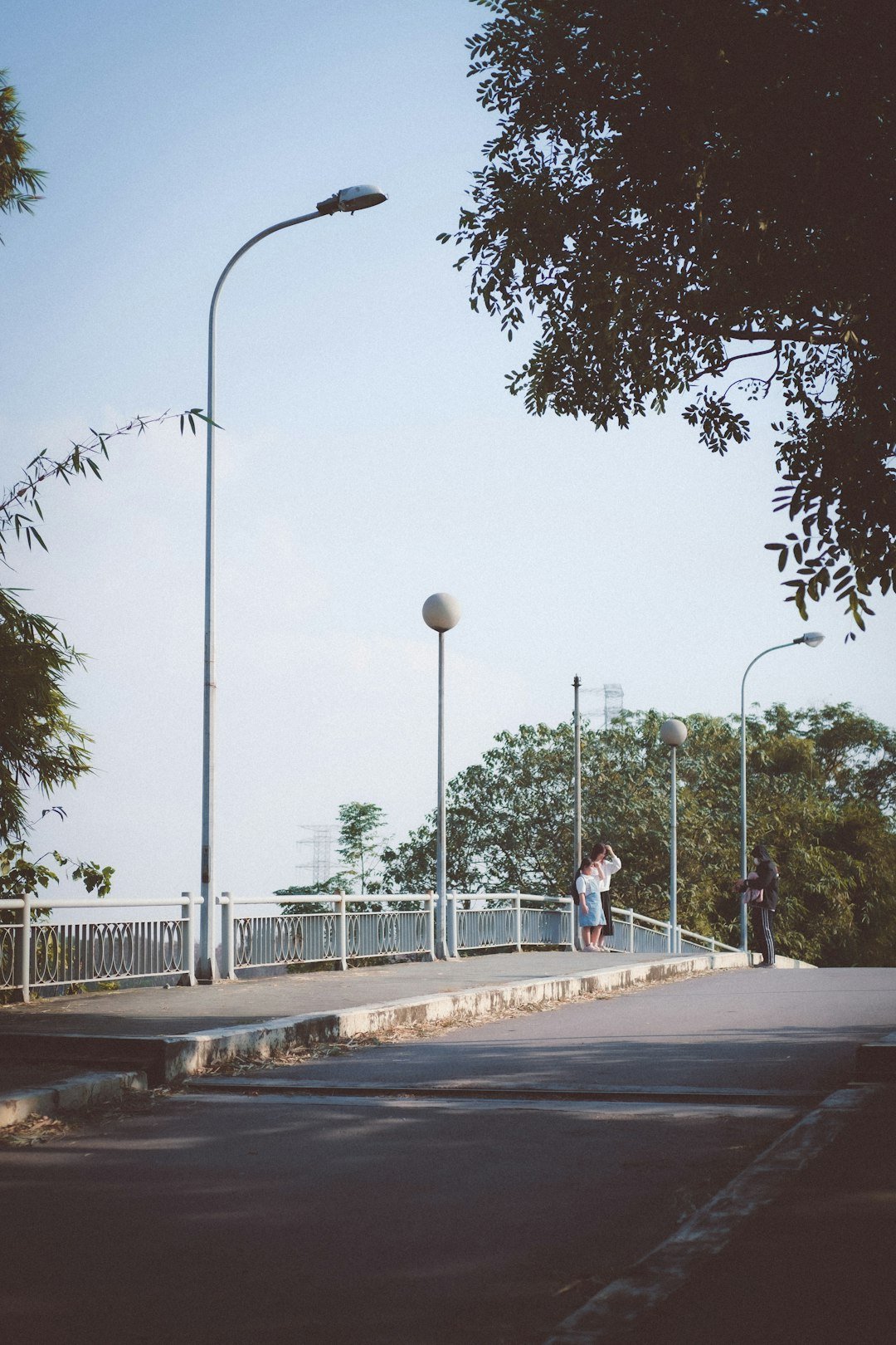 a couple of people walking across a bridge