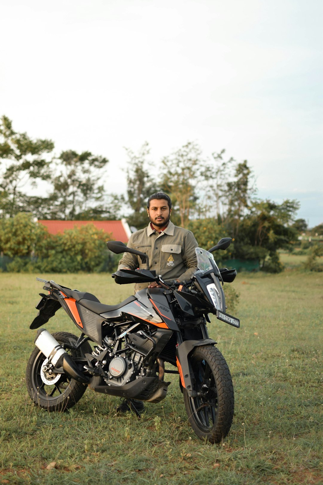 A man sitting on a motorcycle in a field
