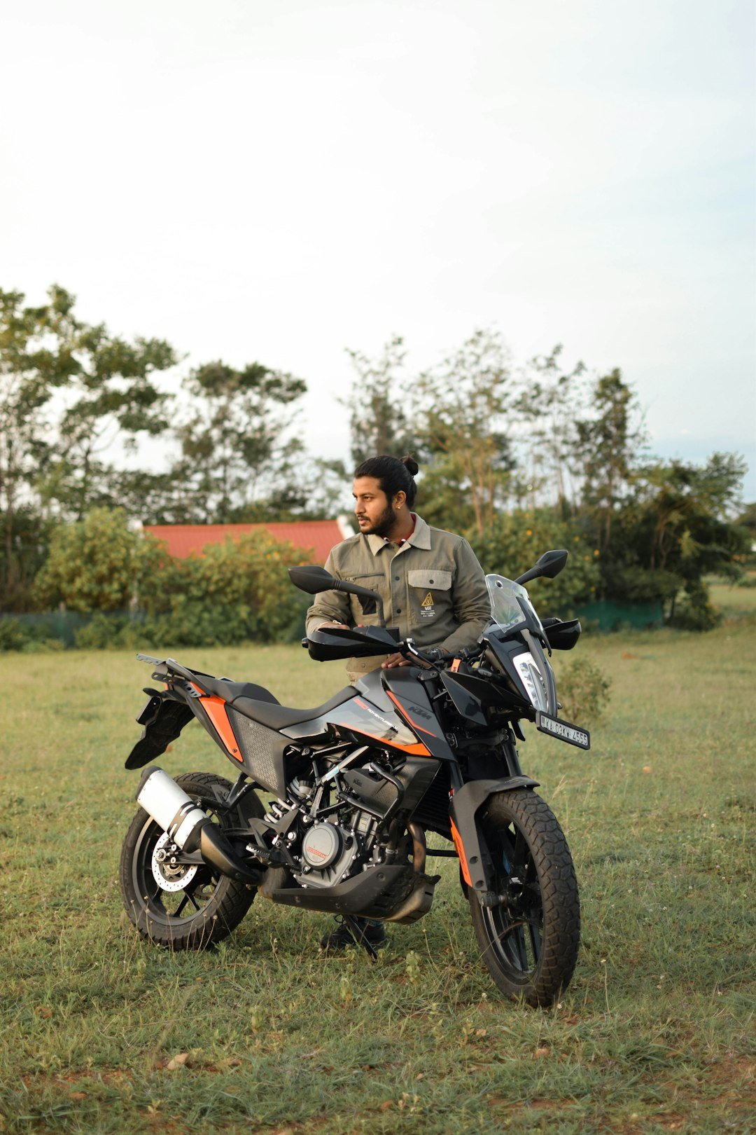 A man sitting on a motorcycle in a field