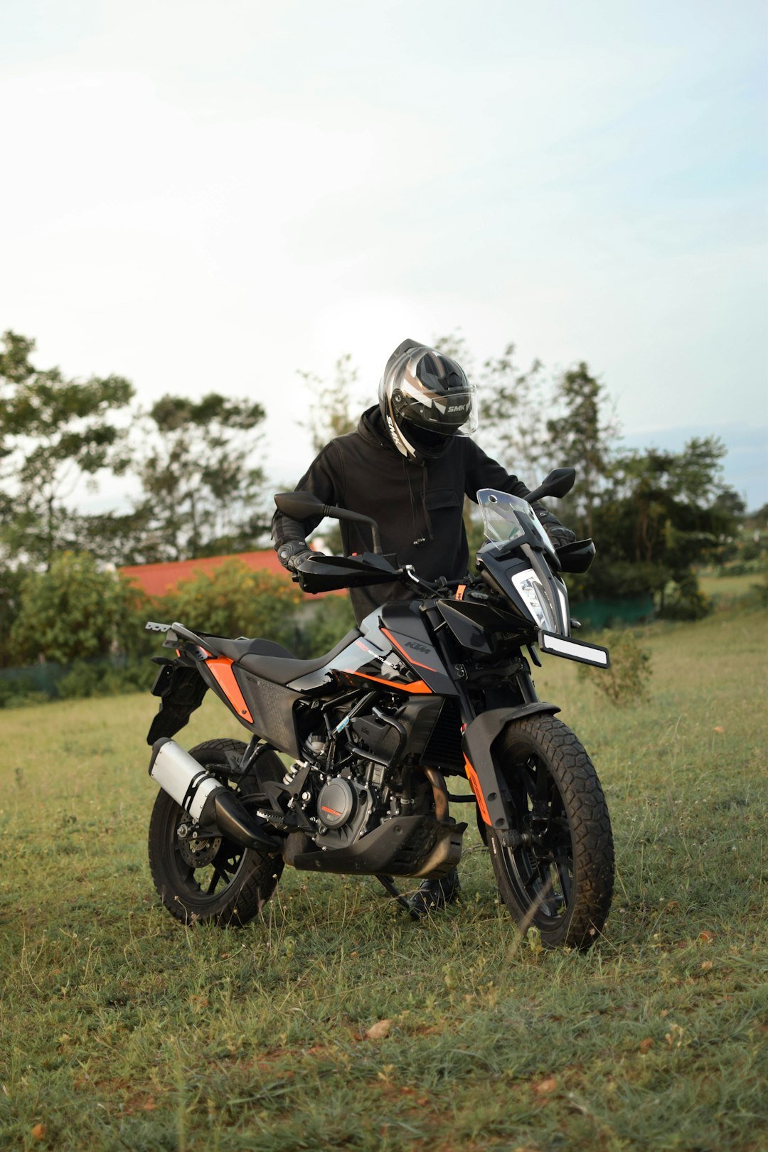 A man riding a motorcycle on top of a lush green field