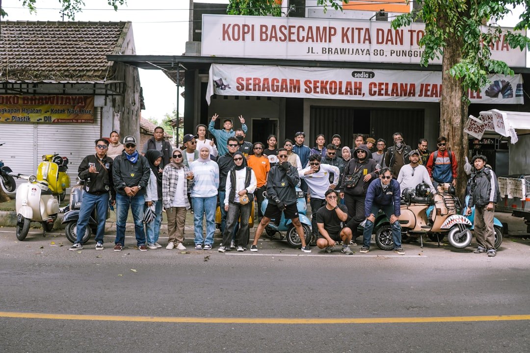 A group poses in front of a coffee shop.