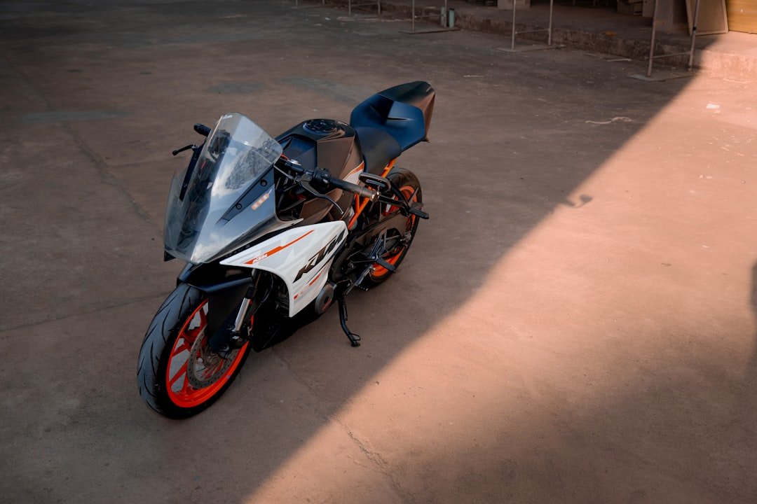 A sportbike is parked on a concrete surface.