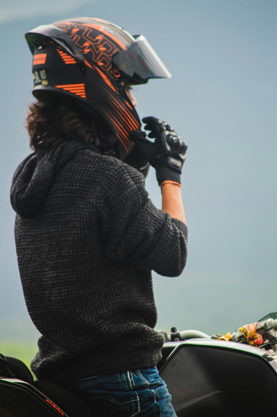 A person on a motorcycle with a helmet on