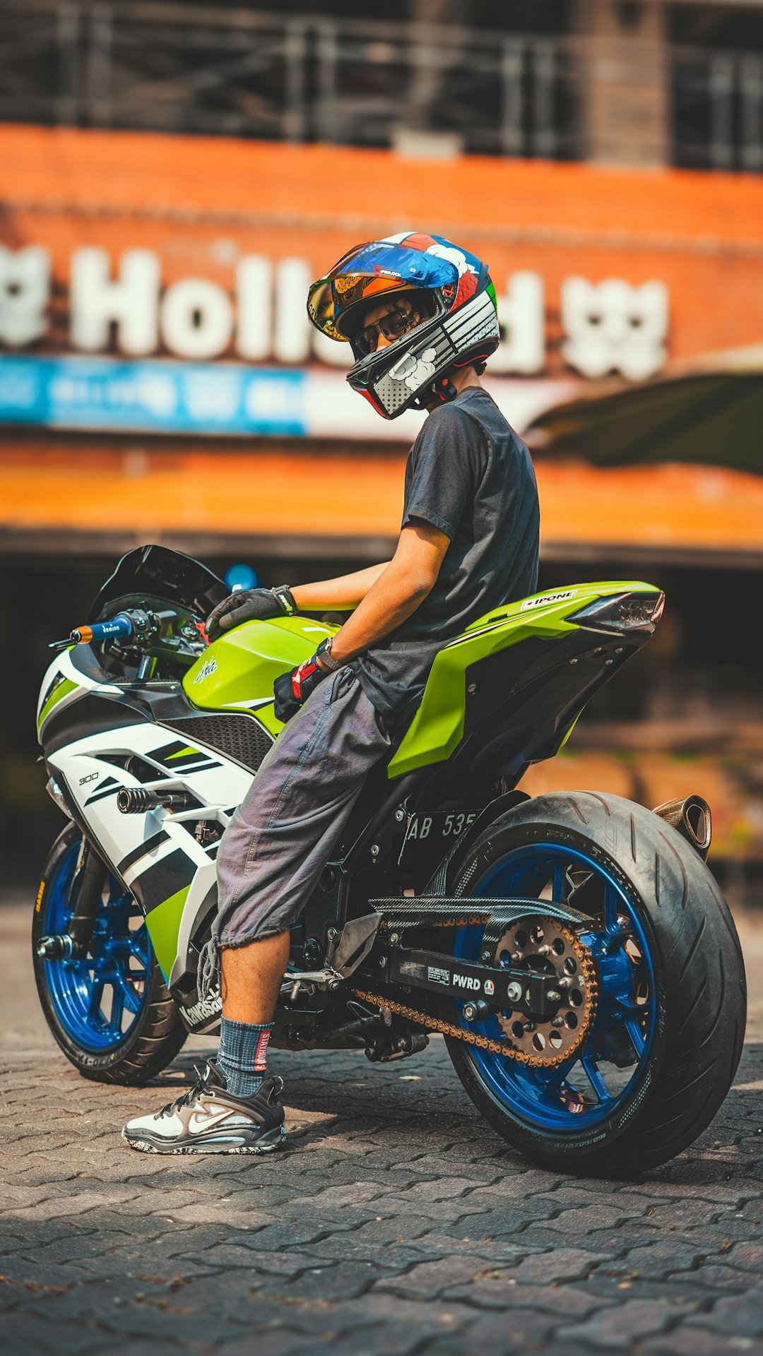 a man sitting on a motorcycle with a helmet on