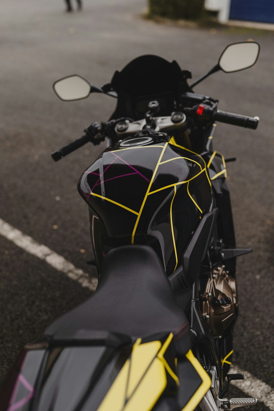 A motorcycle parked in a parking lot next to a building