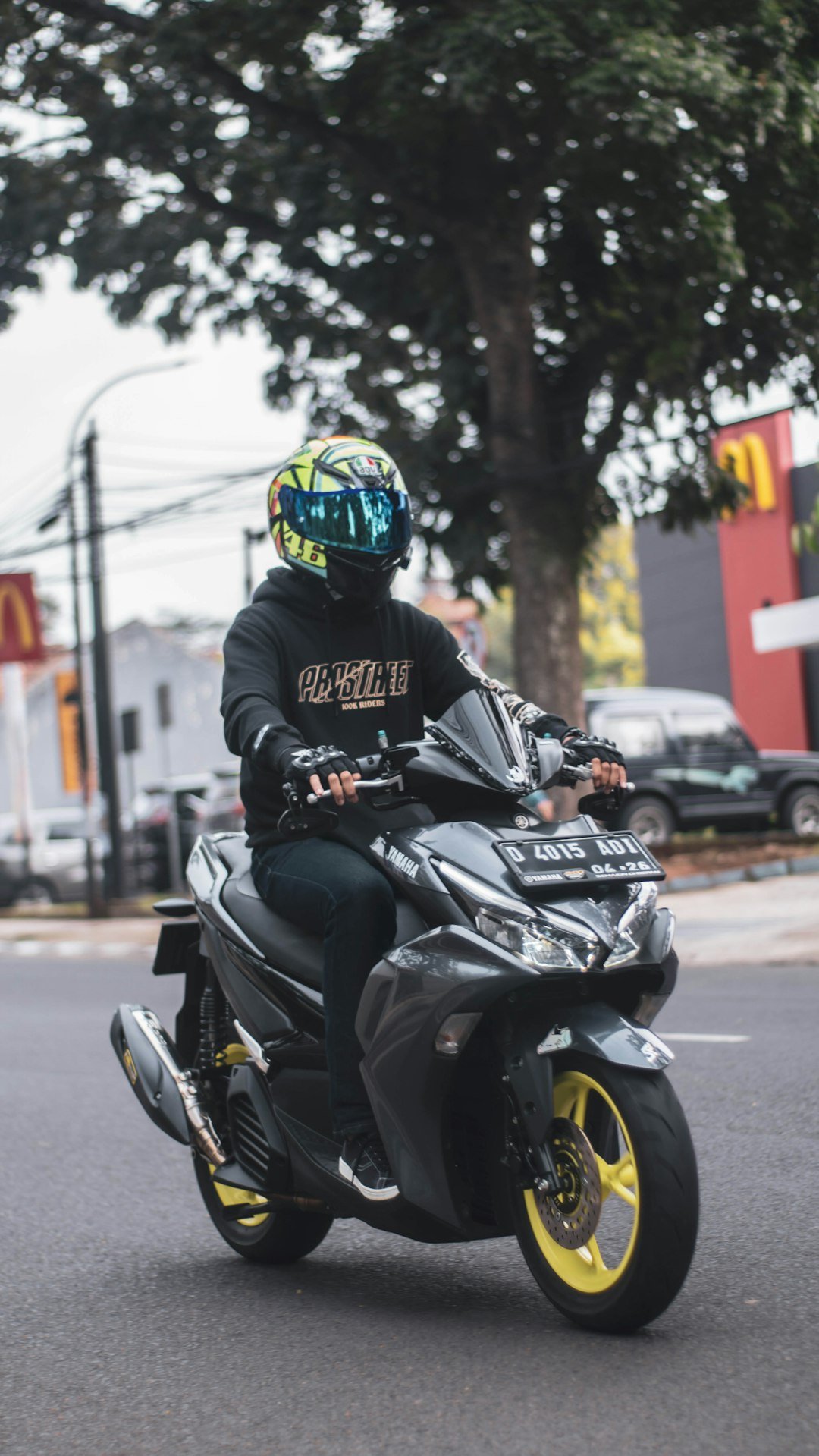 a man riding a motorcycle down a street