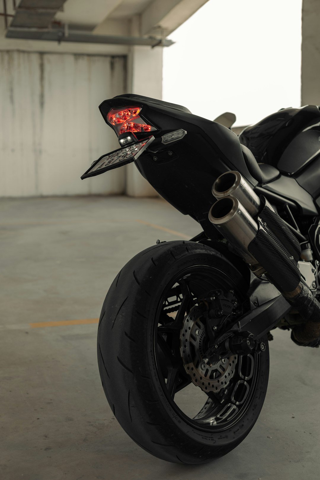 a black motorcycle parked in a parking garage