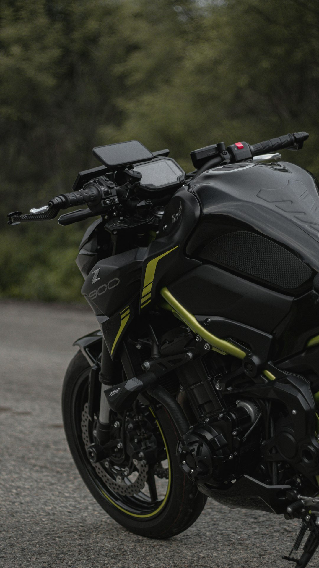 a black and yellow motorcycle parked in a parking lot