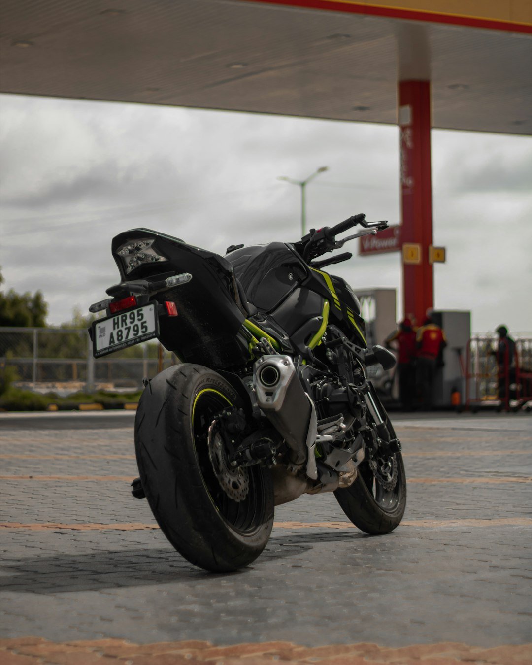 a motorcycle parked in front of a gas station