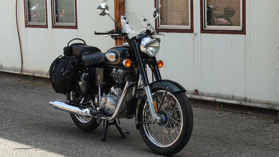 a black motorcycle parked in front of a building